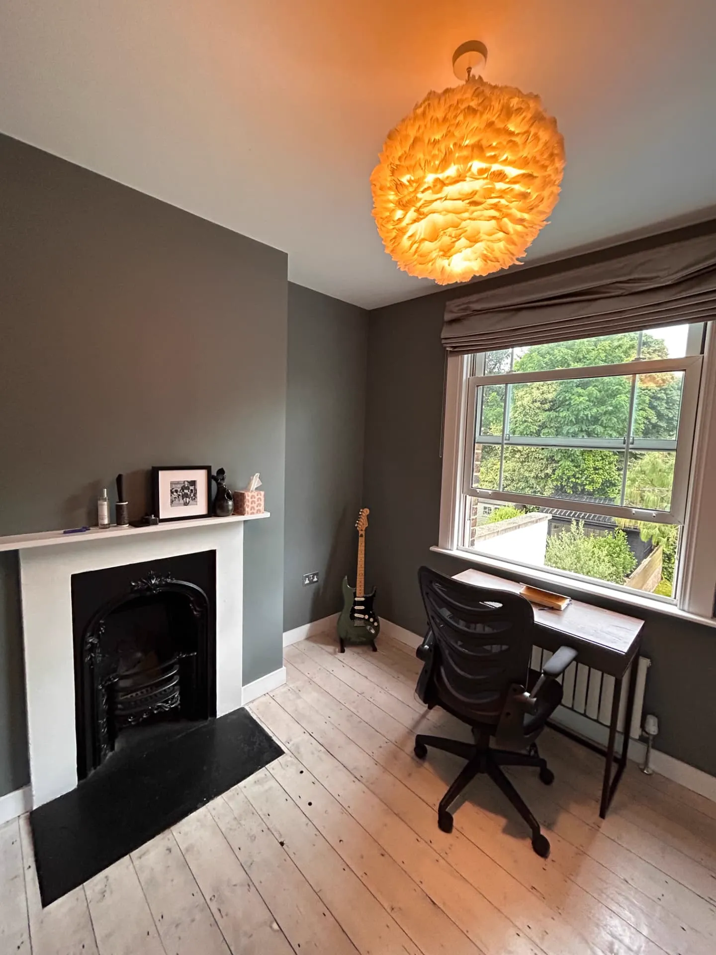 Finished grey home office with a white fire surround and sash window, painting and decorating in Greenwich by coreMaint